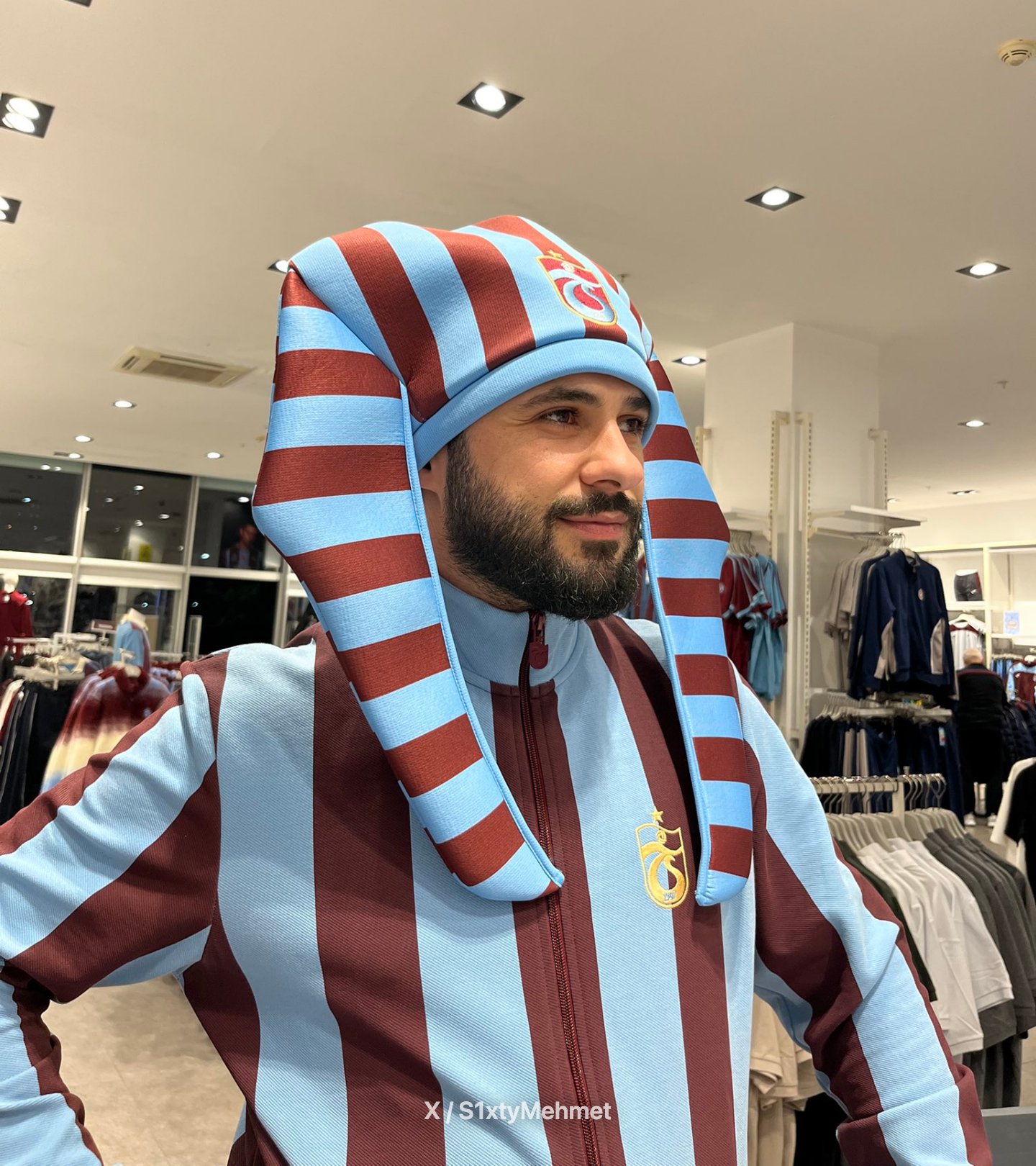 مشجع يجرب غطاء الرأس الفرعوني