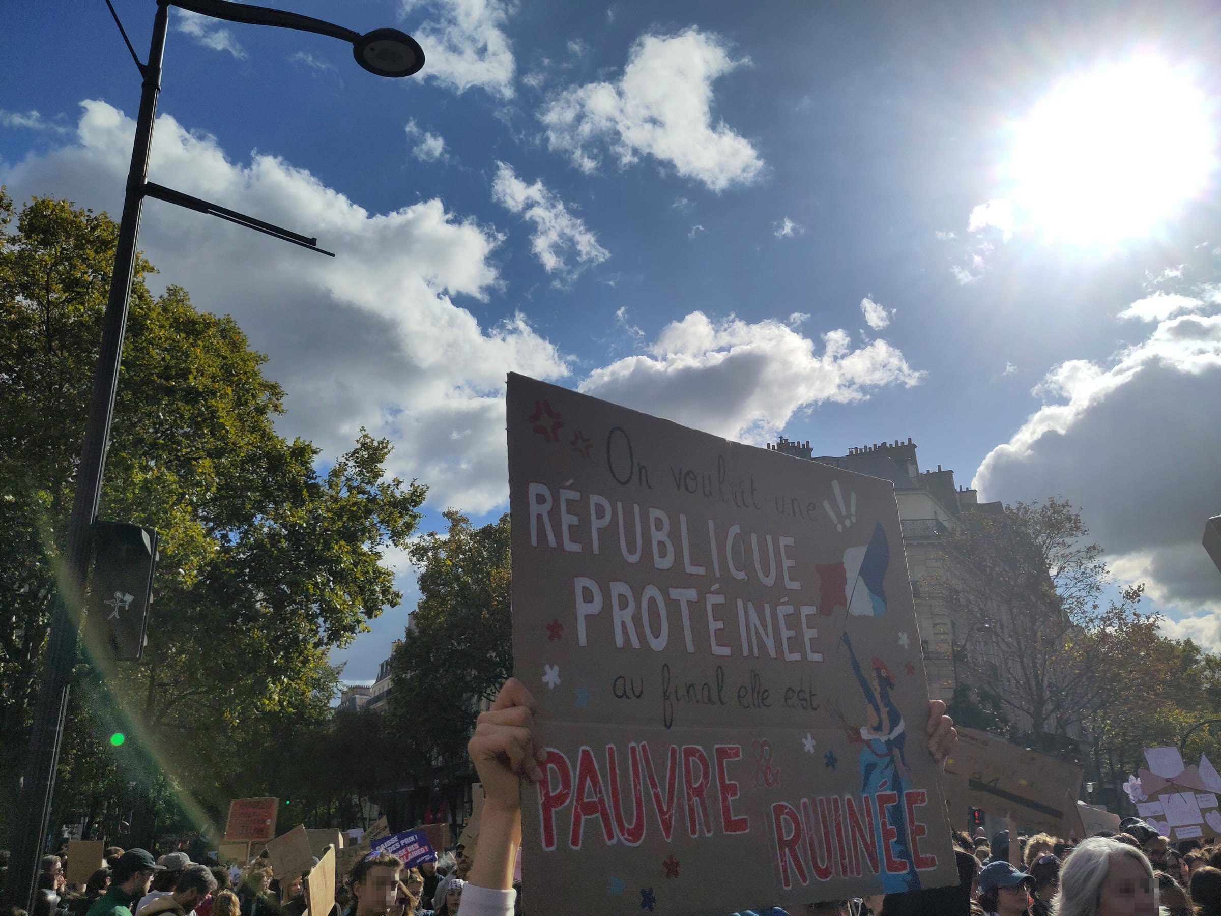 Demonstrators holding placards at the Oct. 17 protest in Paris