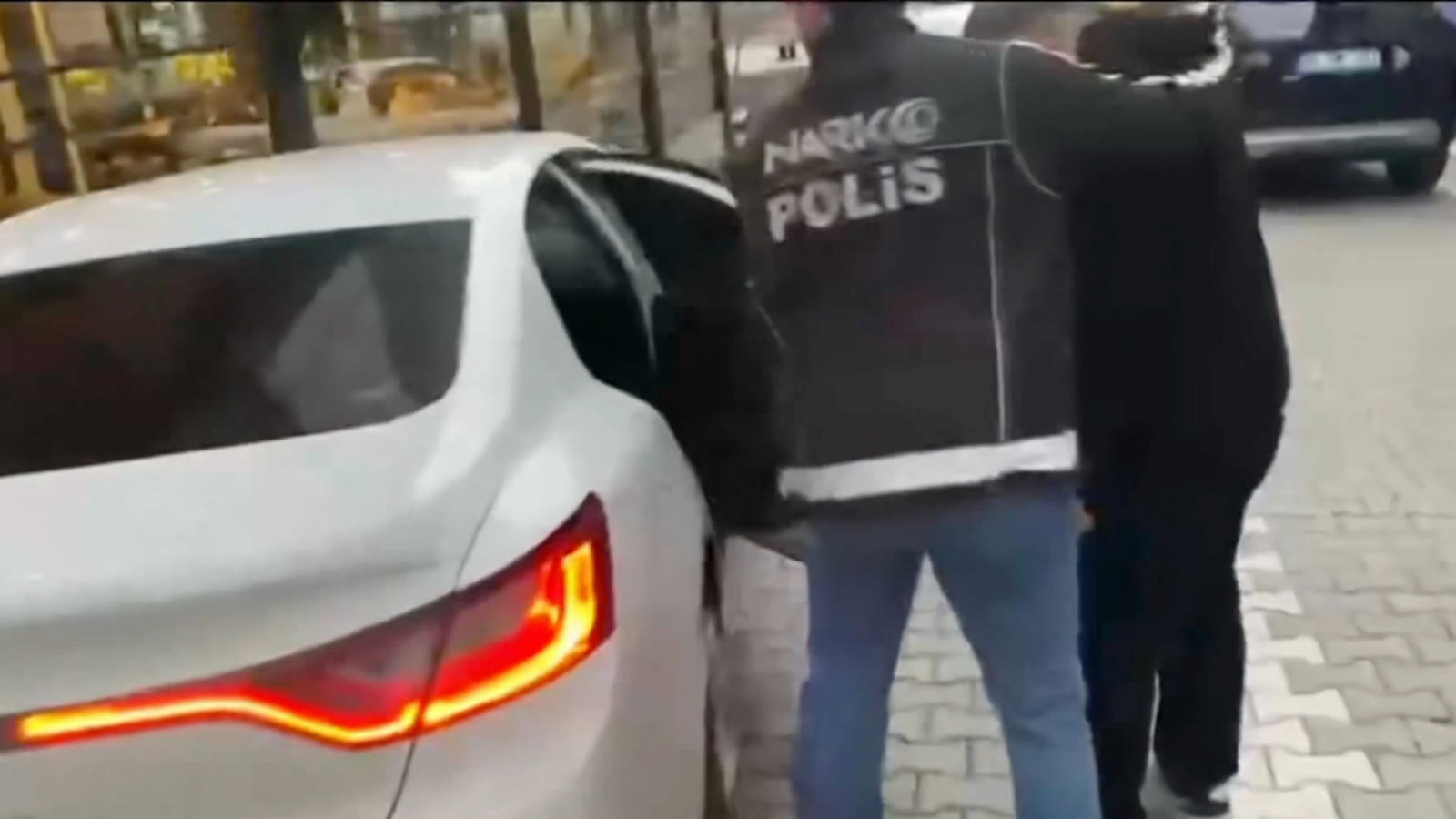 Narcotics police escort a suspect detained in the operation