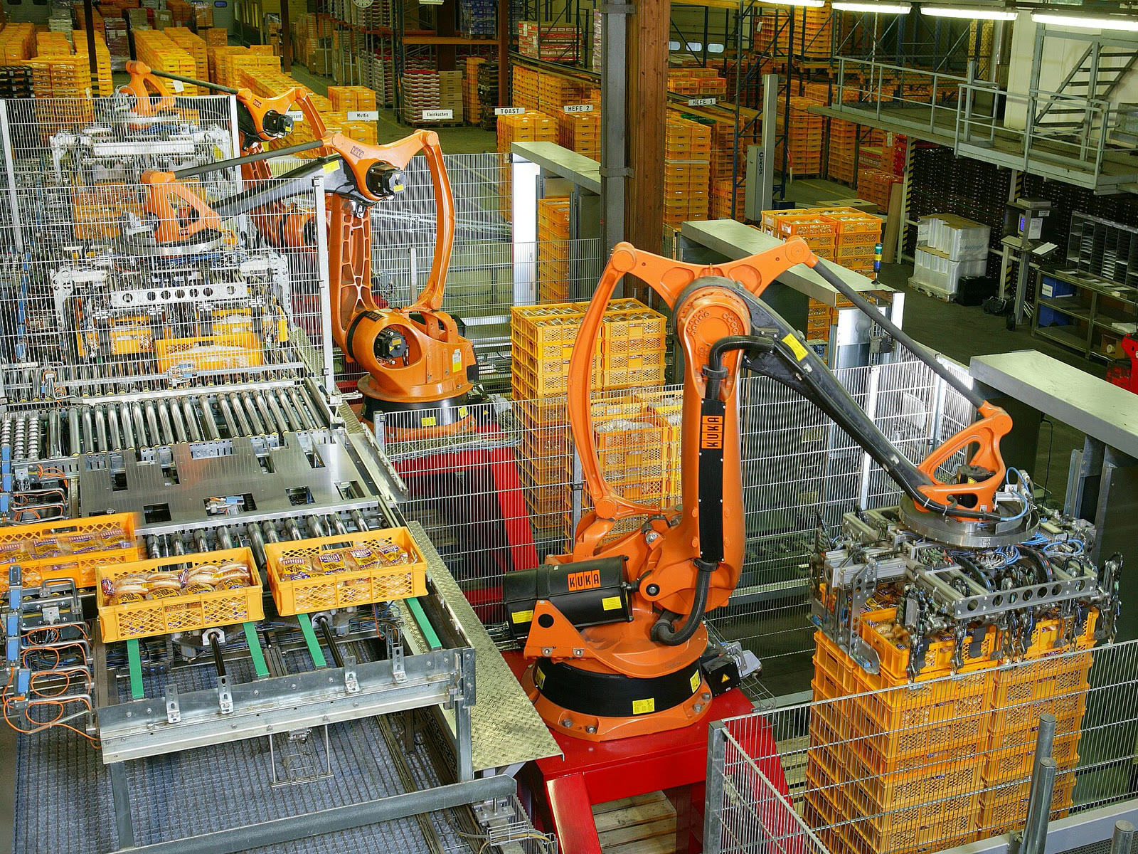Industrial robots packaging products in a factory (archive)