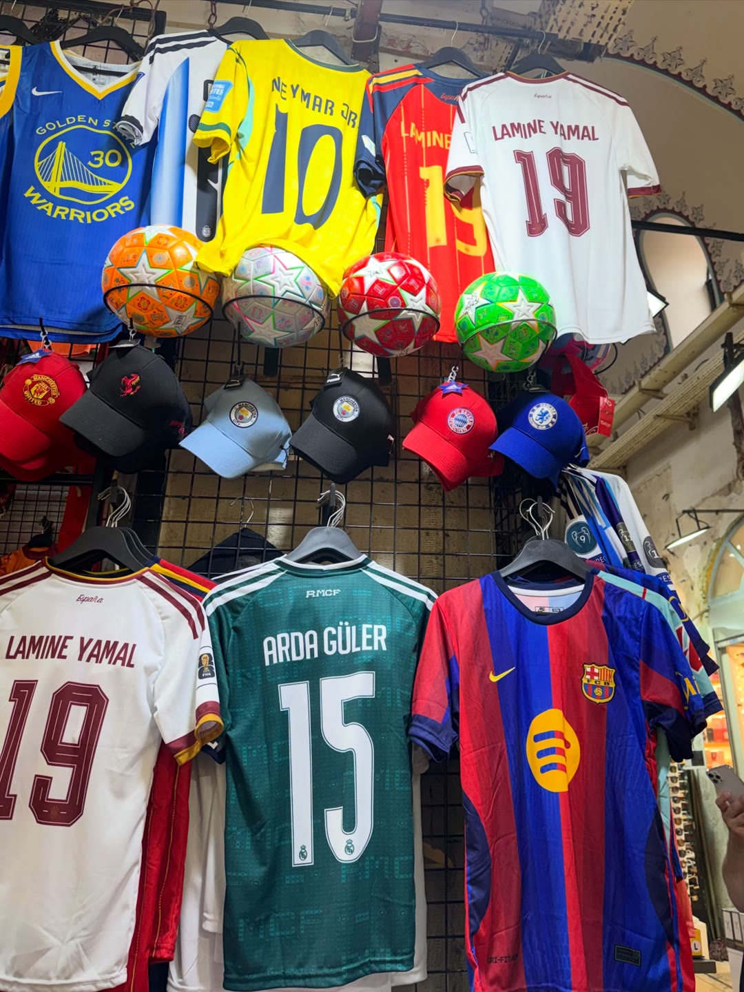 Lamine Yamal and Arda Güler jerseys in a shop