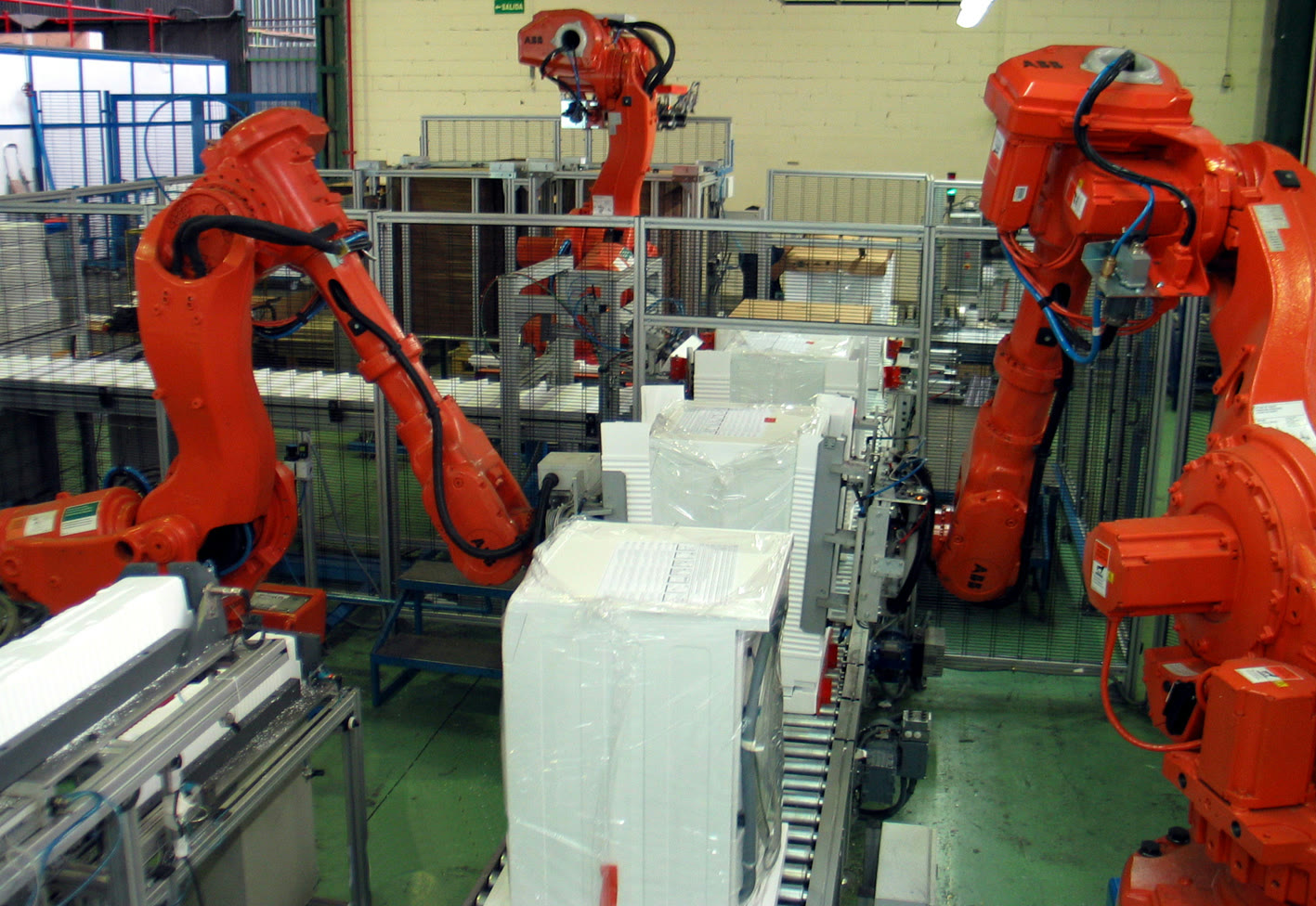 Robotic arms on an automated packaging line (archive)