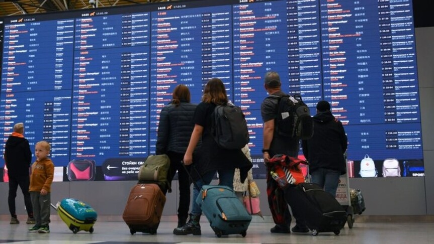 Passengers in front of the flight information screen at Sheremetyevo Airport